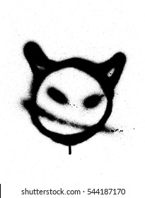 graffiti sprayed devil emoticon in black on white