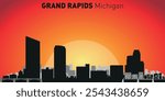 Grand Rapids city skyline with silhouettes of buildings against the backdrop of a large yellow sun and orange sky. Vector on the background of sunset