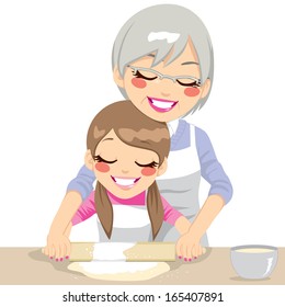 Granddaughter and Grandmother making handmade pizza dough using rolling pin