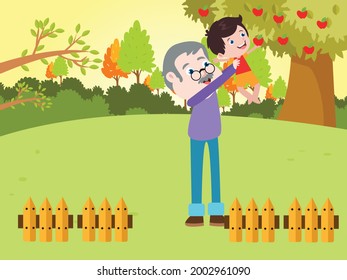 Grandfather helping his grandson picking apple fruit on the tree at the garden