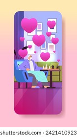 grandfather in love playing chess senior man sitting in armchair valentines day celebration concept living room interior with pink hearts