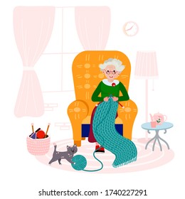 Grandma knitting quilt of yarn in cozy armchair. Old woman happy with her hobby in living room. Elderly Lady with cat in interior.