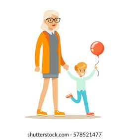 Grandmother And Boy With Balloon Holding Hands Walking, Part Of Grandparents Having Fun With Grandchildren Series