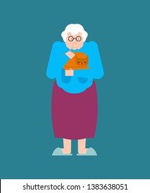 Grandmother and cat. Granny strokes pet. Old lady and kitten in hands
