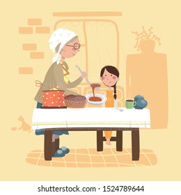 grandmother gives food to her granddaughter. girl is sitting on a chair. they are in the kitchen.