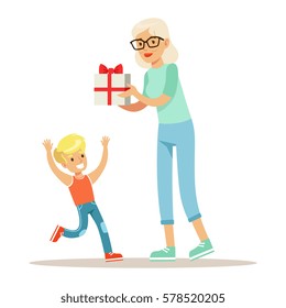 Grandmother Giving Present To Boy, Part Of Grandparents Having Fun With Grandchildren Series
