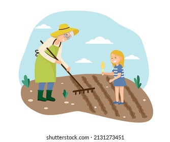 Grandmother and granddaughter plant seeds in the garden