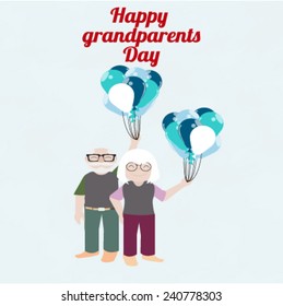 grandmother and grandfather holding blue and white balloons
