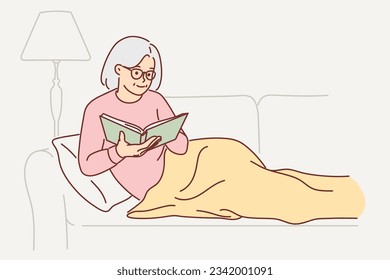 Grandmother is reading book sitting on couch, covering legs with blanket and enjoying exciting plot from fiction literature. Grandmother sits in cozy apartment reading encyclopedia before going to bed