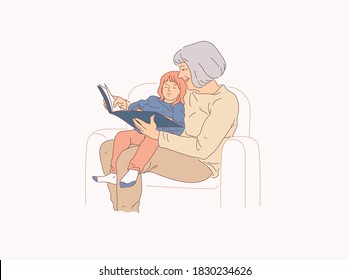 Grandmother reads fairy tales to her little granddaughter. Old lady and little girl concept. Family, care and home comfort.