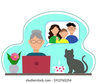 Grandmother sits at a table with a laptop, communicates with her son and his family on the Internet, on the table: a flower, a cup of tea and a cat