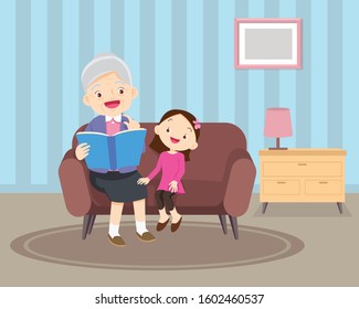 grandmother  sitting with grandchildren on sofa with the book