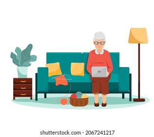 A grandmother is sitting on a green sofa with a laptop. Knitting is lying on the couch next to it. There is a basket with balls of yarn. Flat style. a happy elderly woman. Vector illustration