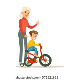 Grandmother Teaching Boy To Ride Bicycle, Part Of Grandparents Having Fun With Grandchildren Series