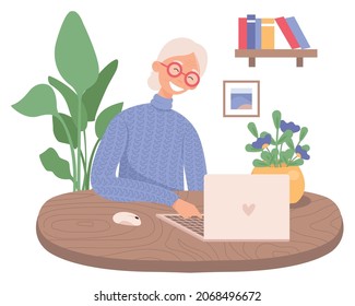 Una abuela que usa el ordenador portátil. Una anciana linda trabajando en un ordenador portátil en casa. Tecnología moderna y gente mayor.