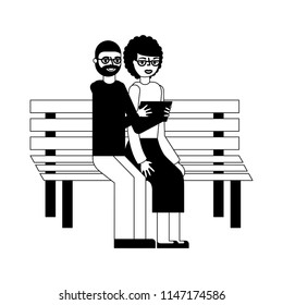 grandparents with tablet device sit in the bench