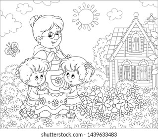 Granny and her little grandchildren smiling and hugging among flowers on a lawn in front of a village house on a sunny summer day, black and white vector illustration in a cartoon style