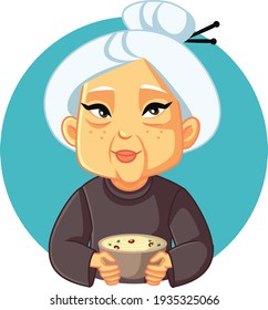 Granny Holding Homemade Noodles Soup Bowl. Cute senior female home cook holding traditional meal
