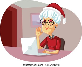 Granny Saluting Family on Christmas Video Call. Senior woman spending winter holidays social distancing
