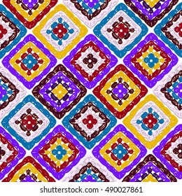 Granny squares pattern and Ripples Afghan. Crochet blanket of square elements, handmade, multicolored knitted squares, cozy blanket.