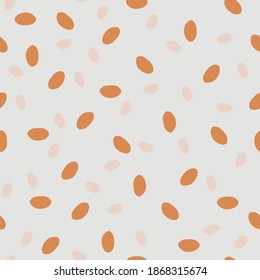 Granola print - healthy food. Geometric seamless pattern with orange and beige ovals on a grey isolated background. Graphic dots, peas, uneven edges. Great for fabric, wallpaper, textile, wrapping.