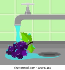 Grape being cleaned and washed in a sink in a kitchen. Running tap water.