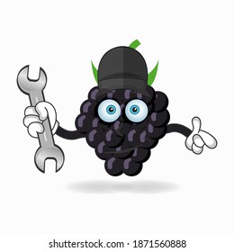 The Grape mascot character becomes a mechanic. vector illustration