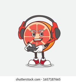 Grapefruit cartoon mascot character play a game with headphone and controller