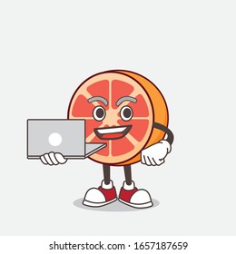 Grapefruit cartoon mascot character working with laptop
