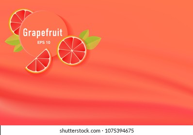 grapefruit minimal  background with slices of this fruit and waves of juice fabric on background