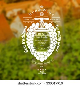 Grapes bunch with barrel for text in the center and vintage press up. Wine label on vineyards and house blurred background