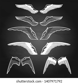 Graphic collection of stylized wings. Vector art for old school tattoo design isolated on chalkboard background