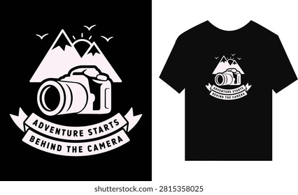 A graphic design featuring a camera and mountain illustration with the text adventure starts behind the camera printed on a black tshirt