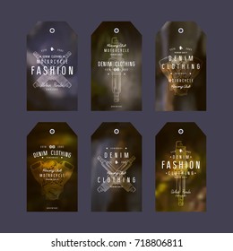 Graphic design of tags for denim clothing. Typographic composition on blurred background