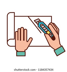 graphic designer hands cutting a paper