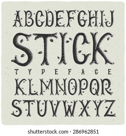 Graphic handmade font made of stylized wooden sticks. Dark on light background.
