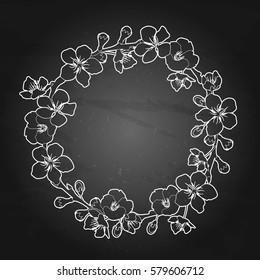 Graphic sakura wreath. Traditional symbol of spring in Japan. Vector floral design isolated on the chalkboard