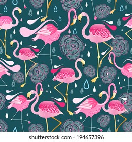 Graphic seamless pattern with bright flowers and flamingos against a dark background  