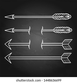 Graphic set of arrows isolated on the chalkboard. Vector tattoo design drawn in old school style