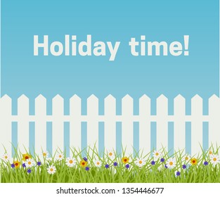 Grass and white fence on a blue sky background. Spring and Summer scene.