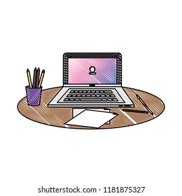 grated office laptop with papers and pencils in the cup