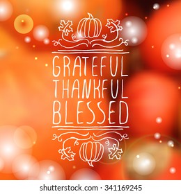 Grateful, thankful, blessed. Hand sketched graphic vector element with pumpkins, maple leaves and text on blurred background. Thanksgiving design.