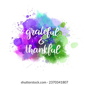 Grateful and thankful - inspirational handwritten modern calligraphy lettering text on abstract watercolor paint splash background.