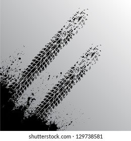 Gray background with grunge tire tracks and ink blots