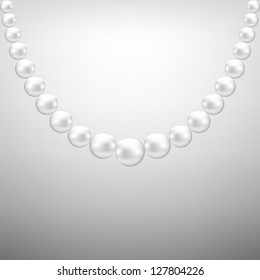 Gray background with hanging white pearl necklace