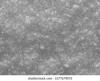 Gray background with white spots and small dots of different sizes