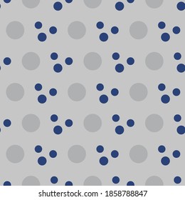 Gray and blue geometric pattern of small and large circles. Dark blue and gray circles on a gray background.