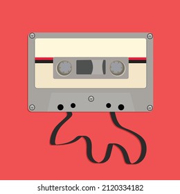 gray cassette with tape out on pink background