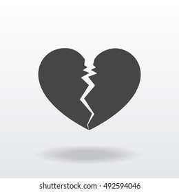 Gray and flat cracked broken heart icon with shadow.