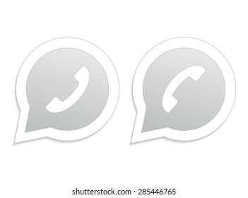 Gray phone handset in speech bubble icon.